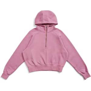A pink cotton half-zip jumper with a hood and cropped design, featuring a logo.