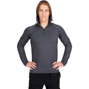 A grey men's half-hood top with a zippered neck and a snug fit. The model stands with hands on hips, showcasing the design.