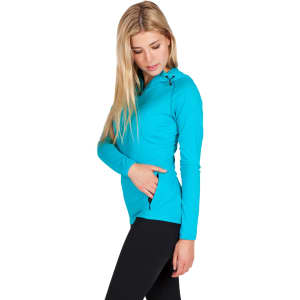 A woman wearing a turquoise half-hood top with long sleeves and a zippered pocket. The top features a logo.