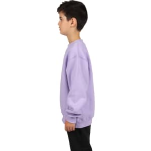 A side view of a child wearing a lilac crew neck jumper, featuring long sleeves and a simple design.