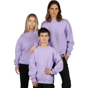 A group of three individuals wearing lilac crew neck jumpers, with a logo on one of the garments.