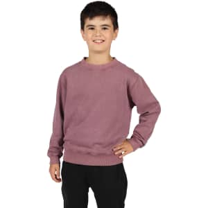 A unisex stone wash sweatshirt in a soft mauve colour, worn by a child standing with one hand on their hip.
