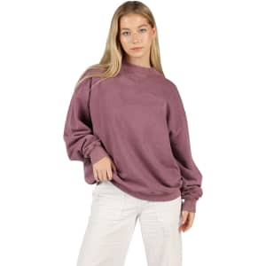 A unisex stone wash sweatshirt in a muted mauve colour, featuring a relaxed fit and long sleeves.