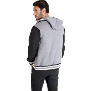 A men's varsity jacket in grey and black with a hood, featuring a logo on the back.