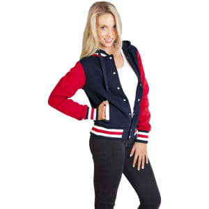 A women's varsity jacket in navy and red with a front zipper, featuring white stripes and a logo.