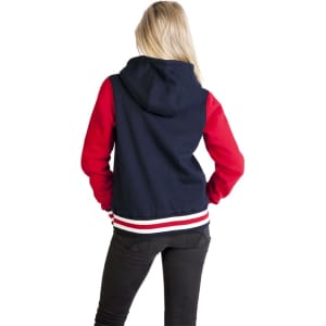A women's varsity jacket with a navy body and red sleeves, featuring a hood and a striped hem.