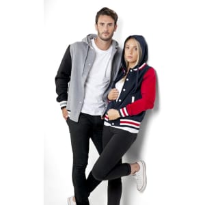 A women's varsity jacket in navy, red, and white, featuring a hood, paired with a grey jacket on a model.