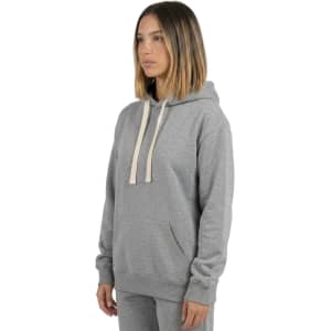 A grey heavy fleece hoodie with a front pocket and drawstring hood, worn by a model against a white background.