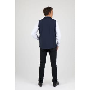 A navy men's soft shell vest displayed on a model from the back, paired with black pants.