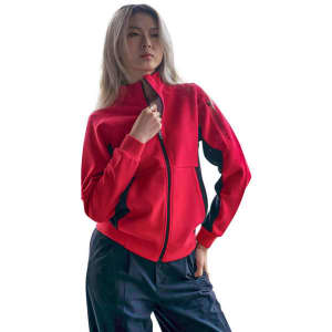 A red women's jacket with black accents, featuring a full zip and stand-up collar. The model poses confidently.