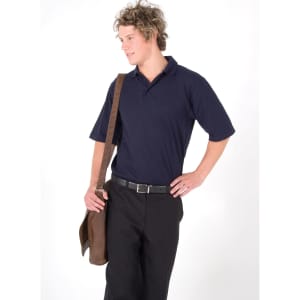 A man in a navy blue polo shirt poses with a brown messenger bag, wearing black trousers and a belt.