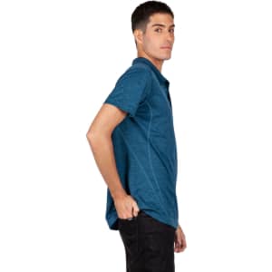 A side view of a men's unisex challenger polyester polo shirt in teal, featuring a subtle texture and a logo.