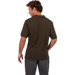 A men's cotton pigment dyed polo shirt in dark green, featuring a short-sleeve design and a logo.