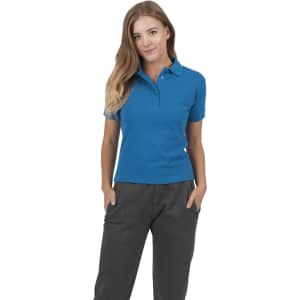 A woman wearing a blue cotton polo shirt with a collar, featuring buttons and a fitted design.
