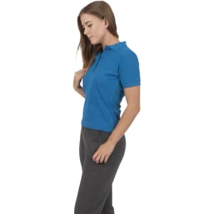 A women's cotton polo shirt in vibrant blue, featuring a collar and short sleeves, worn with grey pants.