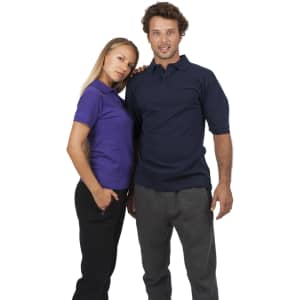 A woman in a purple polo shirt and a man in a navy polo shirt stand together, both smiling.