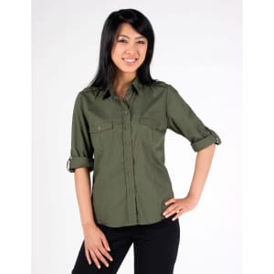 A woman models an olive green women's military long sleeve button-up shirt with rolled sleeves and two chest pockets.