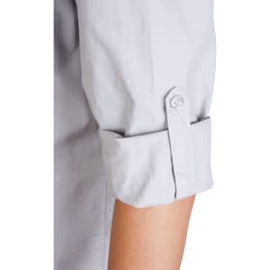 A light grey women's long sleeve military shirt with rolled-up sleeves and a button detail. It features a logo.