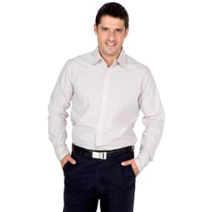 A light-coloured long sleeve button-up shirt worn by a man with a belt, posing with hands in pockets.