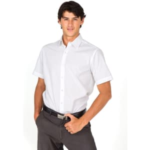 A men's short sleeve button-up shirt in white, featuring a collar and a neat fit, paired with dark trousers.