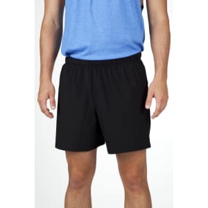 Black men's FLEX shorts with a four-way stretch design, showcased on a model wearing a blue top.