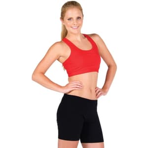 A model wearing black women's shorts and a red crop top, posing with hands on hips.