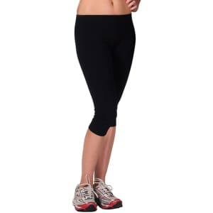 Black women's cotton spandex 3/4 leggings, featuring a fitted style and paired with athletic shoes.