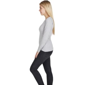 A grey women's long sleeve t-shirt viewed from the side, featuring a fitted design. It has a visible logo.