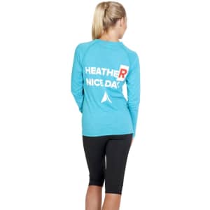 A women's long sleeve T-shirt in heather turquoise with a logo on the back, paired with black leggings.