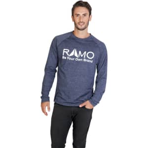 A man wearing a navy long sleeve shirt, featuring a logo on the front, stands against a white background.