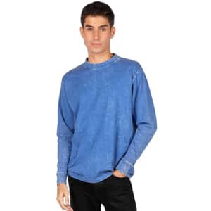A blue stone wash long sleeve t-shirt on a model, featuring a casual fit and a logo.