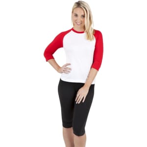 A women's 3/4 sleeve raglan T-shirt featuring red sleeves and a white body, paired with black shorts.