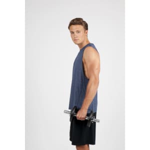 A sleeveless blue heather tee worn by a muscular man holding a dumbbell, set against a plain background.