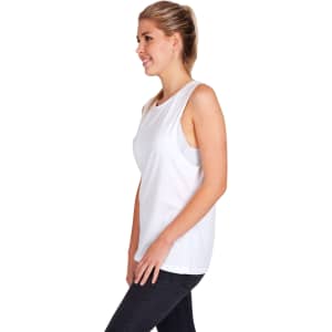 A white women's combed cotton tank top displayed on a model, featuring a simple design and a relaxed fit.