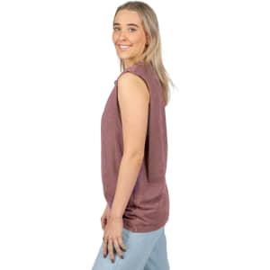 A woman wearing a stone washed purple tank top, featuring a relaxed fit and sleeveless design.