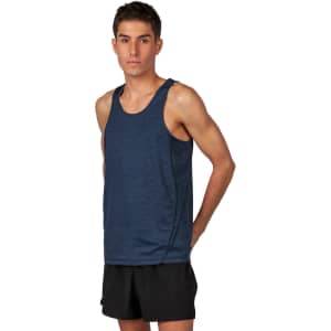 A man in a navy blue polyester singlet stands with his hands behind his back, wearing black shorts.
