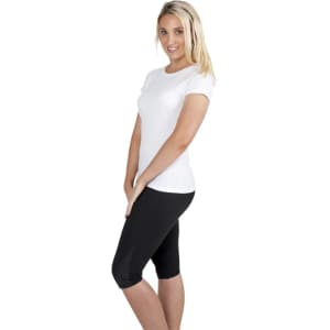 A woman poses in a fitted white slim fit tee paired with black leggings, showcasing a clean and casual look.