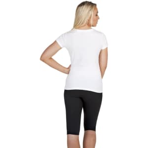 A white women's slim fit tee is displayed, shown from the back, paired with black leggings. The image features a logo.