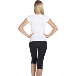 A white women's V-neck T-shirt viewed from the back, paired with black leggings. The shirt has a logo.
