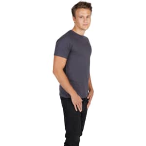 A man poses in a grey men's slim fit T-shirt, paired with black jeans, against a plain white background.