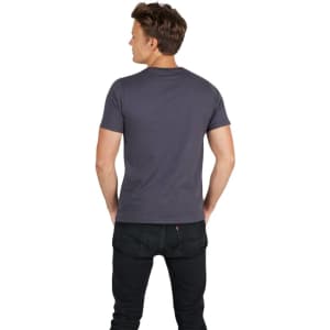 A slim fit men's T-shirt in grey, featuring short sleeves and a crew neck, displayed on a model.