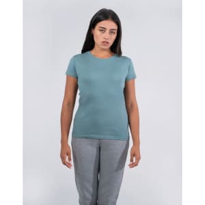 A women's fitted T-shirt in a soft teal colour, displayed on a model wearing grey pants.