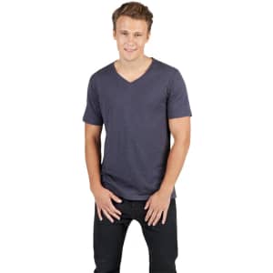 A man poses in a navy raw cotton V-neck T-shirt, paired with black jeans. The shirt has a branding logo.