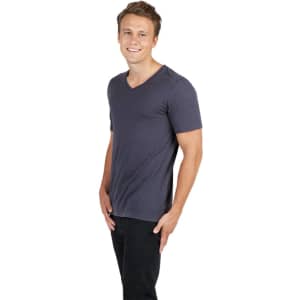 A raw cotton wave v-neck t-shirt in dark grey, modelled by a smiling male with short hair.