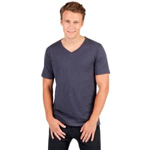 A man models a dark blue, unisex raw cotton V-neck T-shirt. The shirt features short sleeves and a fitted style.