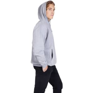 A grey kangaroo pocket hoodie on a model, featured in a side profile with hands in pockets.