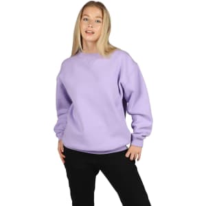 A model wearing a lavender-coloured poly cotton fleece sloppy joe sweater, paired with black pants.