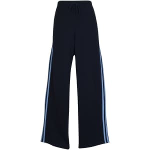 Wide-leg track pants in black with light blue stripes, featuring an elastic waistband and drawstring.