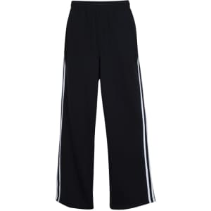 Black striped track pants featuring white side stripes and an elastic waistband. Includes a logo.