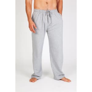 Mens fleece track pants in light grey, featuring an elastic waistband and drawstring. The model stands barefoot.